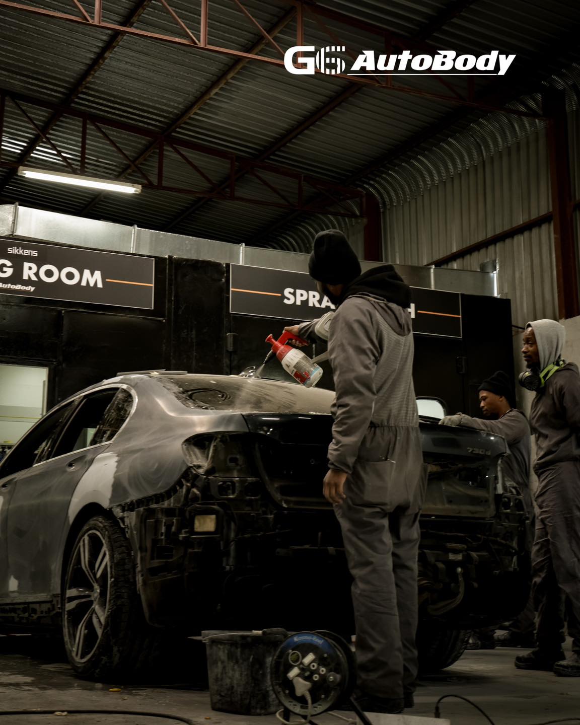 G6 AutoBody technicians prepping a vehicle in the Sikkens spray booth